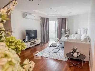 Spacious living room with modern decor and large windows for natural light.