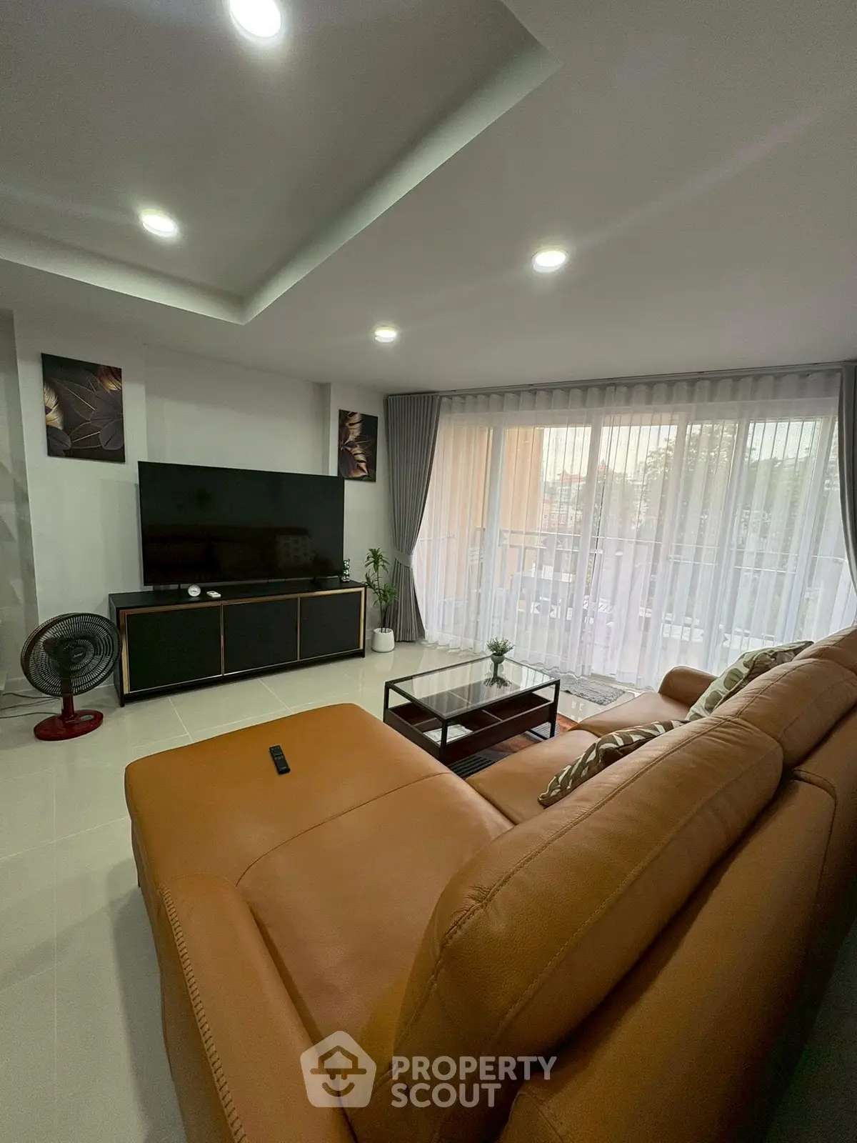Spacious living room with modern decor and large windows for natural light.