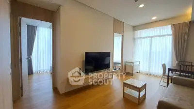 Spacious modern living room with large windows and wooden flooring