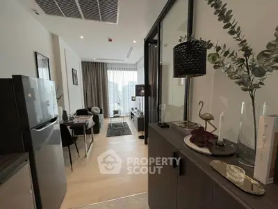 Modern living room with stylish decor and open layout, featuring a cozy seating area and large window view.
