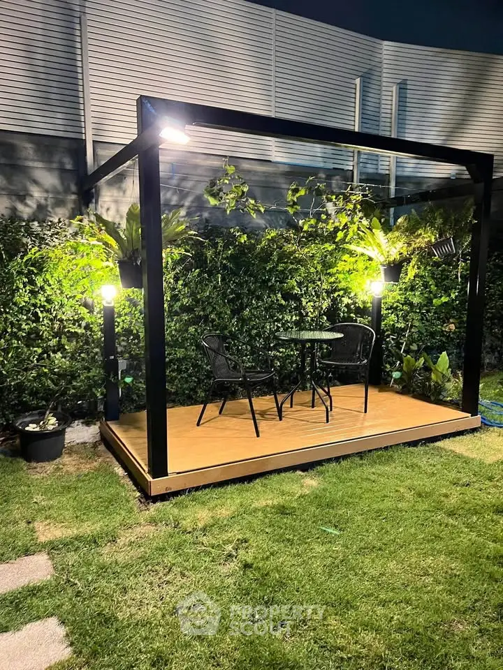 Charming garden patio with modern pergola and cozy seating area, perfect for outdoor relaxation.