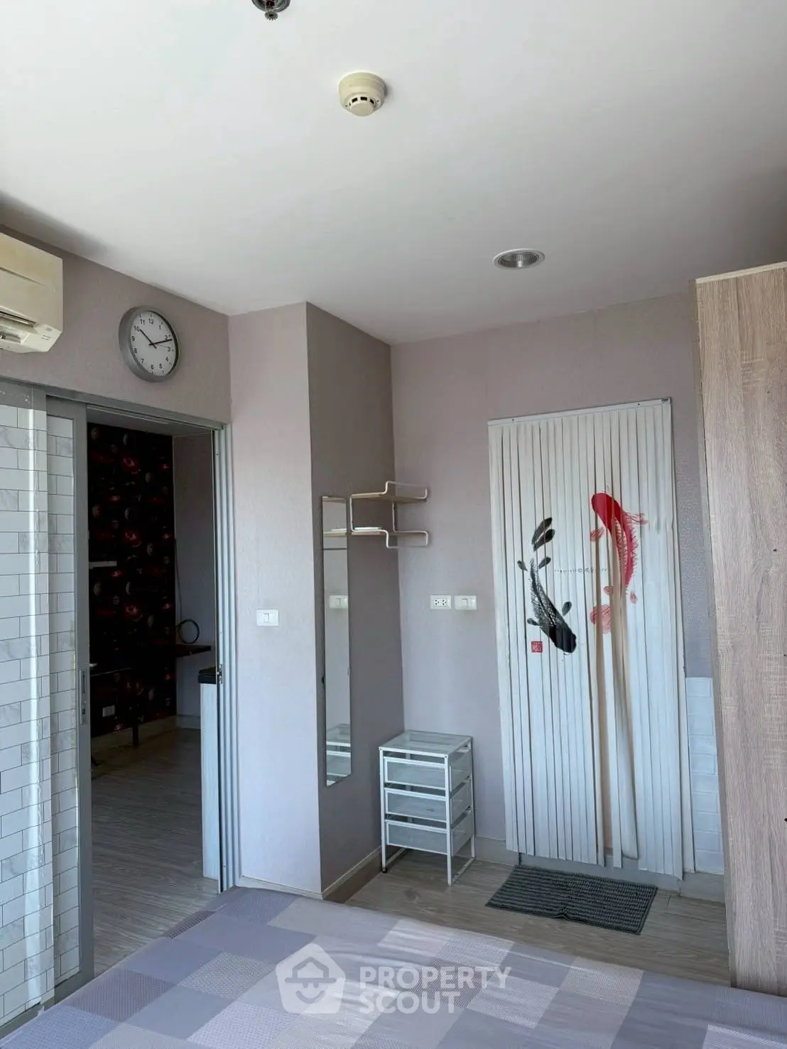 Modern bedroom with stylish decor and air conditioning in a cozy apartment.