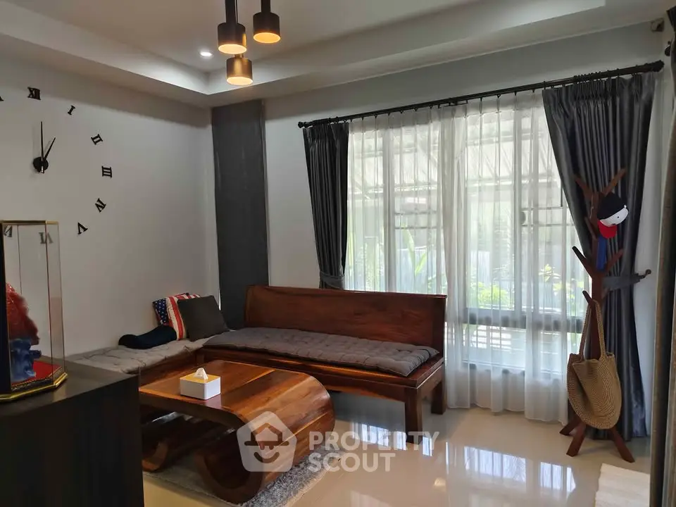 Stylish living room with modern wooden furniture and large window for natural light.