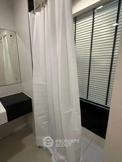Modern bathroom with sleek shower curtain and contemporary design