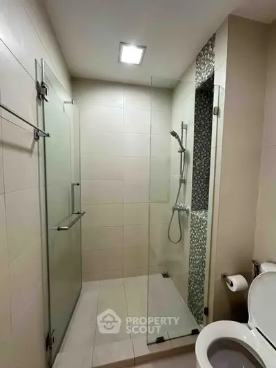 Modern bathroom with glass shower enclosure and sleek tile design