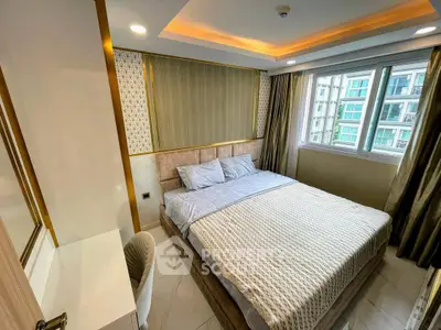 Luxurious bedroom with elegant decor and large window offering natural light in modern apartment.