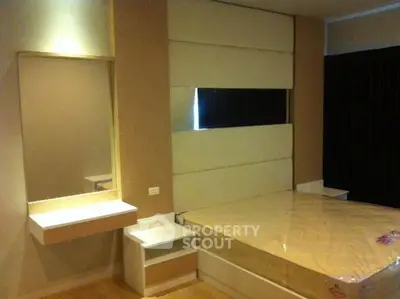 Modern bedroom with stylish headboard and built-in vanity in a cozy apartment.