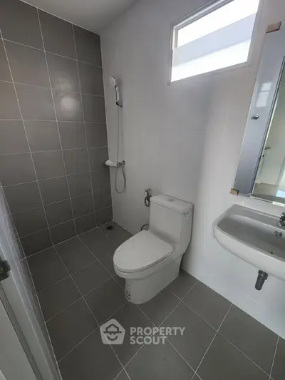 Modern bathroom with sleek tiles and compact fixtures