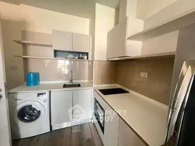 Modern compact kitchen with washing machine and sleek cabinetry