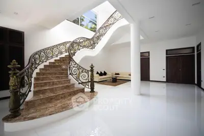 Luxurious modern living room with elegant staircase and stylish decor