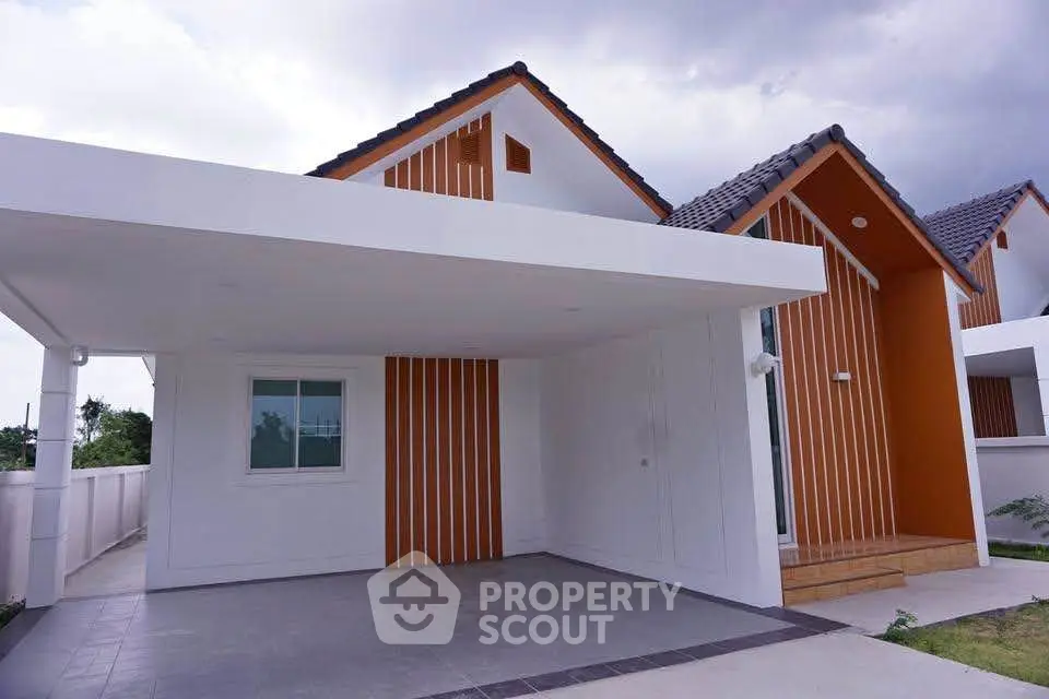 Modern minimalist house exterior with carport and unique architectural design.