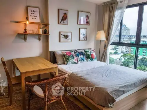 Charming bedroom with city view, stylish decor, and natural light, perfect for urban living.