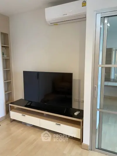 Modern living room with sleek TV setup and air conditioning