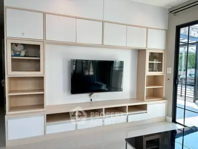 Modern living room with sleek TV unit and ample storage space