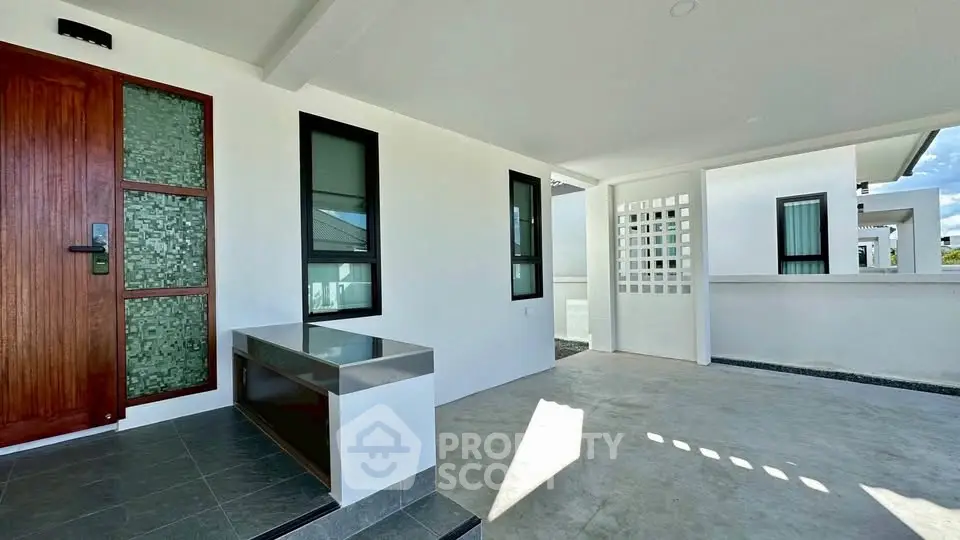 Modern exterior entrance with sleek design and ample natural light.