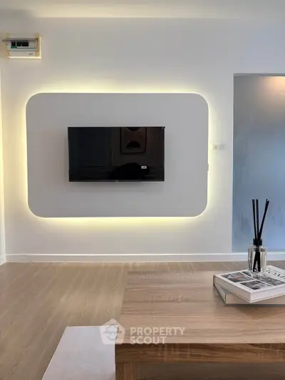 Modern living room with sleek TV setup and ambient lighting