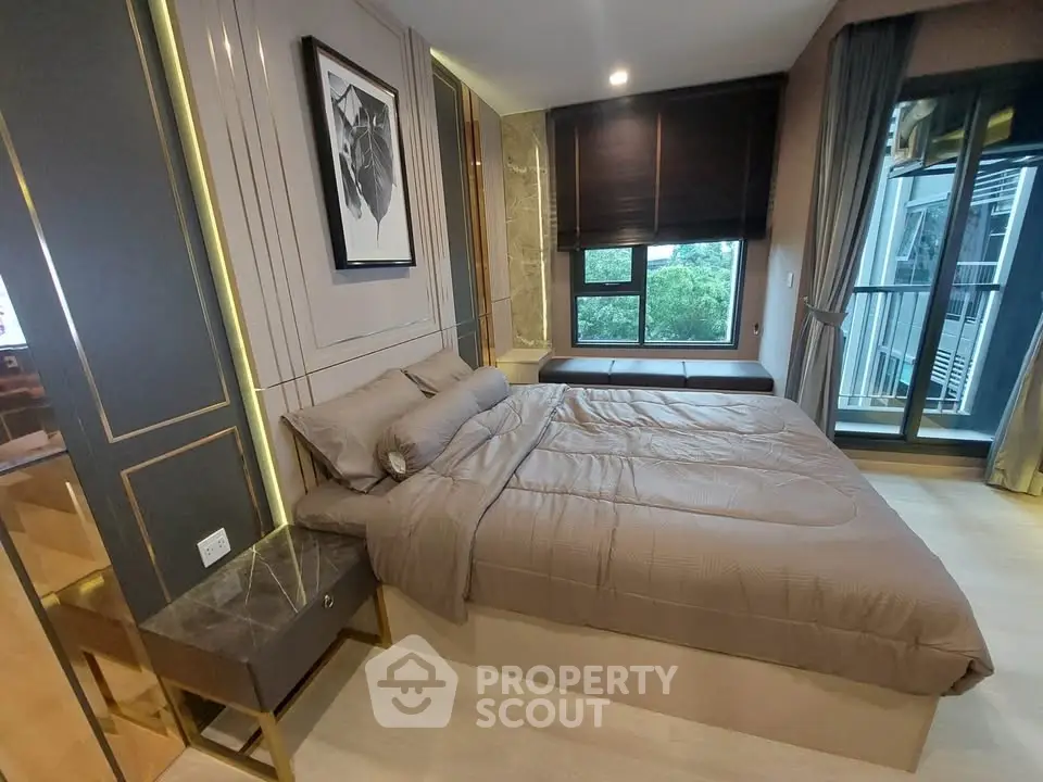 Luxurious modern bedroom with elegant decor and large window offering serene views.
