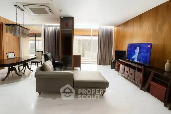 Spacious modern living room with elegant decor and large TV