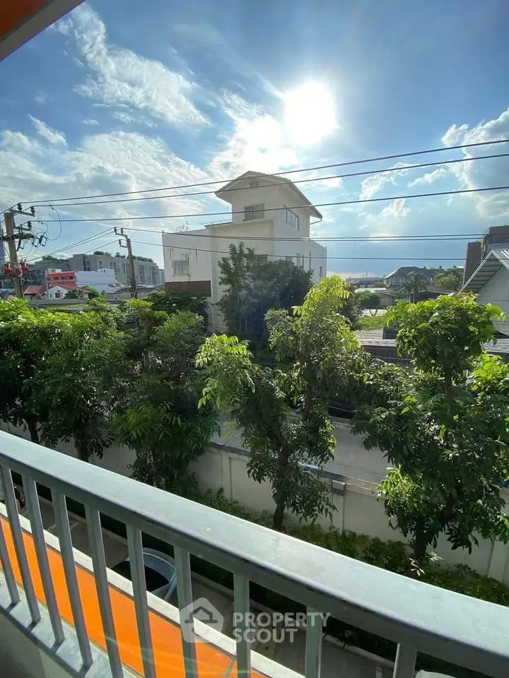 Stunning balcony view with lush greenery and clear blue sky