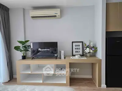 Modern living room with air conditioning, TV, and stylish decor