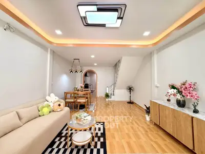 Spacious modern living room with stylish decor and open dining area, perfect for family gatherings.