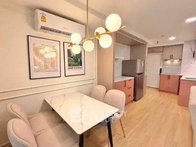 Modern kitchen and dining area with elegant lighting and stylish decor