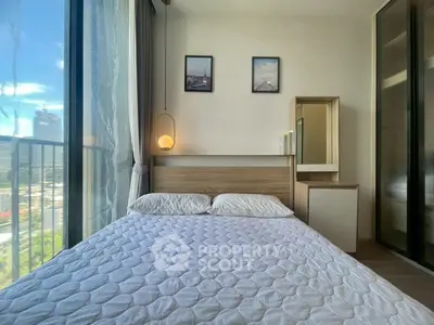 Modern bedroom with large window and city view, featuring stylish decor and cozy ambiance.