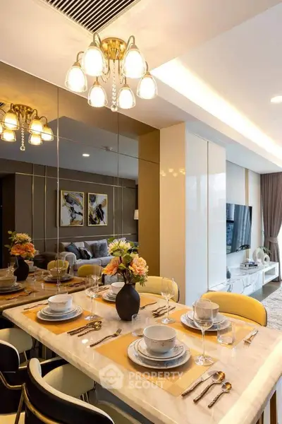 Luxurious dining area with elegant table setting and modern lighting in a stylish apartment.