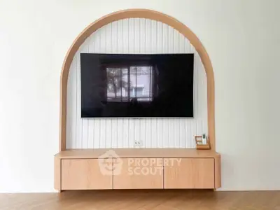 Modern living room with stylish TV unit and wooden arch design, perfect for contemporary homes.