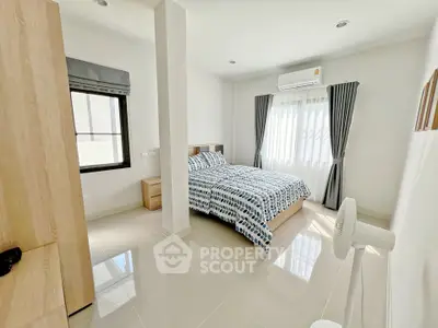 Bright and airy bedroom with modern decor and large window