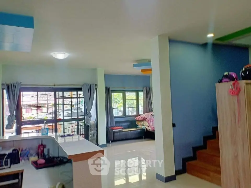 Spacious living room with modern decor and large windows for natural light.