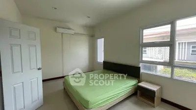 Spacious bedroom with natural light and modern furnishings
