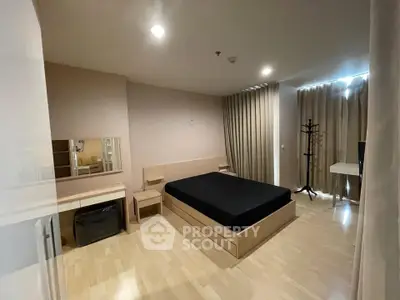 Spacious bedroom with modern furnishings and natural light