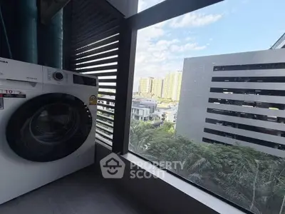 Modern apartment balcony with washing machine and city view