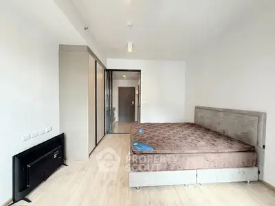 Spacious bedroom with modern furnishings and ample natural light.