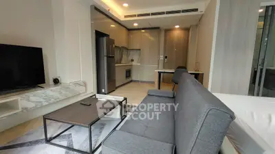 Modern living room with sleek furniture and open kitchen layout