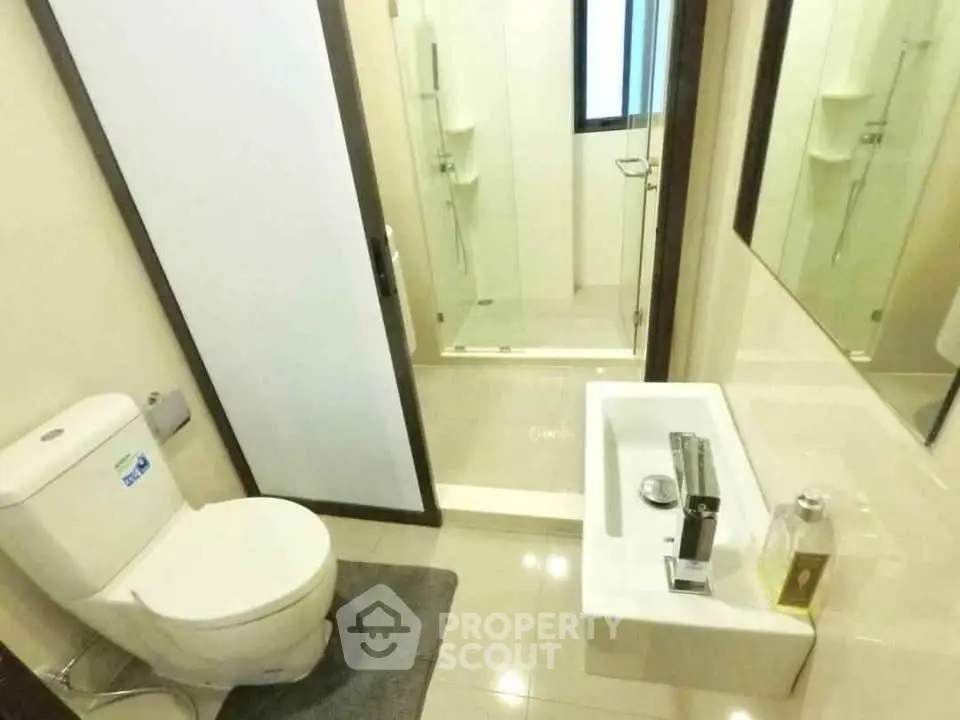 Modern bathroom with sleek fixtures and glass shower enclosure