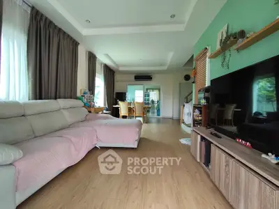 Spacious living room with modern decor and large windows for natural light