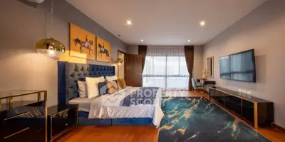 Luxurious bedroom with modern decor, plush bedding, and stylish lighting in a high-end apartment.