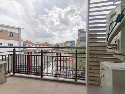 Spacious balcony with urban view, perfect for relaxation and enjoying cityscapes.