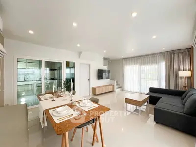 Spacious modern living room with dining area and large windows