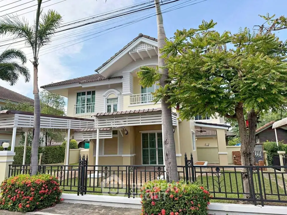 Charming two-story house with lush garden and elegant facade in a serene neighborhood.