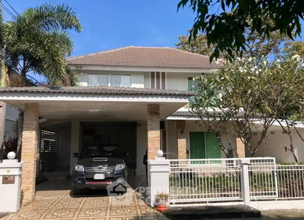 Charming suburban house with carport and lush greenery, perfect family home.