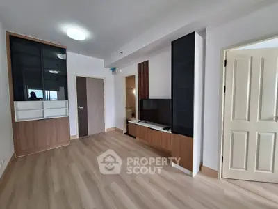 Modern living room with sleek wooden flooring and built-in TV unit