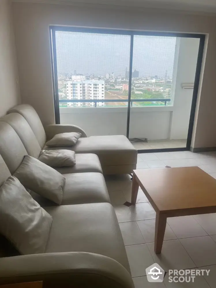 Spacious living room with city view and modern furniture