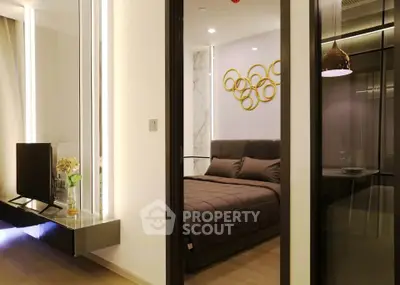 Modern bedroom with stylish decor and ambient lighting in luxury apartment.