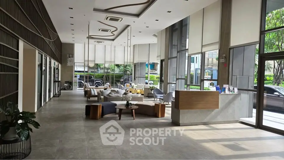 Modern lobby with stylish seating and large windows in a contemporary building