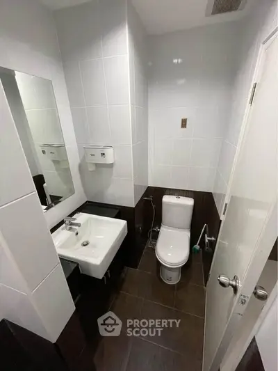Modern bathroom with sleek fixtures and contemporary design in a real estate property.