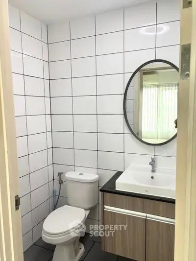 Modern bathroom with sleek design and round mirror