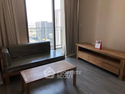 Modern living room with wooden furniture and city view from large window.